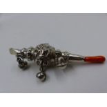 A VICTORIAN BABIES SILVER RATTLE. THE RATTLE FEATURES AN ADDITIONAL WHISTLE AND A PIECE OF