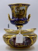 A DERBY CAMPANA SHAPED VASE PAINTED WITH A SCENE ENTITLED NEAR DUMBAR SCOTLAND. H.17cms AND A LIDDED