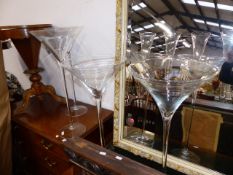 FOUR LARGE CLEAR MARTINI GLASS VASES. H.71cms.