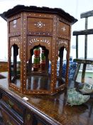 AN ANTIQUE INDIAN STYLE HARDWOOD AND INLAID OCTAGONAL TOP OCCASIONAL TABLE ON FOLDING LEGS.