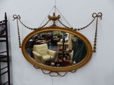 THREE OVAL FRENCH STYLE MIRRORS, A TWIN LIGHT GIRONDOLE, A SWAG DECORATED NEOCLASSIC DESIGN