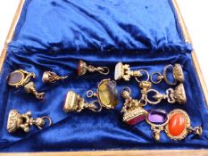 A SELECTION OF STONE SET GILT FOBS TO INCLUDE TWO 9ct GOLD EXAMPLES.