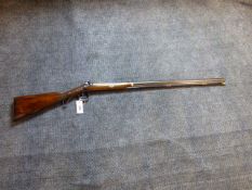 A 19th.C.PERCUSSION SPORTING SHOTGUN WITH DAMASCUS BARREL, FOLIATE ENGRAVED LOCK PLATE AND HAMMER.