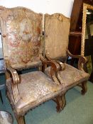 A PAIR OF SPANISH LARGE ARMCHAIRS WITH GILT DECORATED FRAMES AND EMBOSSED LEATHER UPHOLSTERY.