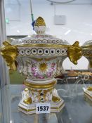 A PAIR OF CONTINENTAL PORCELAIN LIDDED POT POURRI WITH MASKED DESIGNS. H.20cms.