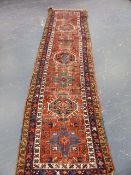 AN ANTIQUE PERSIAN HERIZ RUNNER. 308 x 86cms.