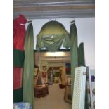 A BESPOKE DOME TOP ENTRANCE WAY OR BED HANGING IN RIBBED LINED GREEN FABRIC.