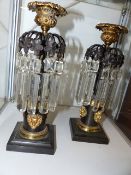 A PAIR OF REGENCY BRONZE AND ORMOLU MOUNTED CANDLE LUSTRES WITH FIGURAL STEMS.