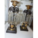 A PAIR OF REGENCY BRONZE AND ORMOLU MOUNTED CANDLE LUSTRES WITH FIGURAL STEMS.