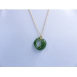 A TIFFANY & CO ETERNAL CIRCLE JADE AND 18ct GOLD ELSA PERETTI PENDANT. APPROXIMATE LENGTH 22cms.