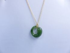 A TIFFANY & CO ETERNAL CIRCLE JADE AND 18ct GOLD ELSA PERETTI PENDANT. APPROXIMATE LENGTH 22cms.