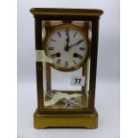 A LATE VICTORIAN/EDWARDIAN BRASS CASED FOUR GLASS TABLE CLOCK WITH 8-DAY MOVEMENT STRIKING ON