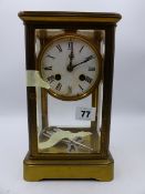 A LATE VICTORIAN/EDWARDIAN BRASS CASED FOUR GLASS TABLE CLOCK WITH 8-DAY MOVEMENT STRIKING ON