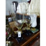 A PAIR OF REGENCY STYLE BRASS MOUNTED BLACK MARBLE CANDLESTICKS WITH CLEAR GLASS STORM SHADES AND