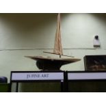 A LARGE EDWARDIAN POND YACHT ON A PERIOD DISPLAY STAND.