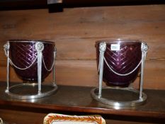 A PAIR OF AMETHYST COLOURED GLASS CACHE POTS WITH PLATED MOUNTS IN THE CLASSICAL STYLE. H.24 x