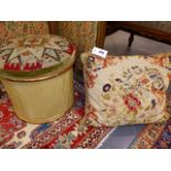 A VICTORIAN GILTWOOD NEEDLEPOINT COVERED OTTOMAN WITH A FLORAL CUSHION COVER OF SIMILAR DATE.