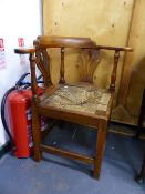 A 19th.C.WALNUT FRAMED CORNER ARMCHAIR WITH DROP IN RUSH SEAT.