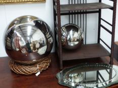 A SHAPED FORM TABLE MIRROR REFLECTOR AND TWO SIMILAR ORBS. LARGEST Dia.36cms. (3)