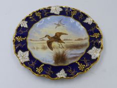 A DERBY PORCELAIN PLATE, SNIPE, SIGNED D BURBECK.