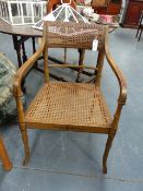 A REGENCY PAINT DECORATED FAUX BAMBOO OPEN ARMCHAIR WITH BERGERE SEAT AND BACK PANEL.