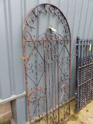 A WROUGHT IRON TALL GARDEN GATE.