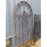 A WROUGHT IRON TALL GARDEN GATE.