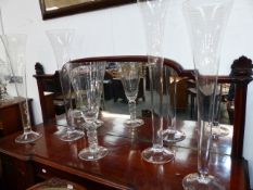 FIVE TALL CLEAR GLASS VASES. FOUR LILY TYPE AND ANOTHER OF WINE GLASS FORM. LARGEST H.118cms. (5)