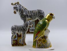 A ROYAL CROWN DERBY PAPERWEIGHTS. ZEBRA AND ZEBRA BABY AND AN AMAZON GREEN PARROT, 267/2500. (3)