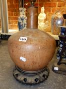 AN UNUSUAL ORIENTAL POTTERY BOTTLE FORM VASE WITH FAUX GOURD GLAZE MOUNTED AS A LAMP ON HARDWOOD