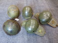 A BRITISH PARATROOPER'S HELMET WITH CANVAS AND LEATHER CHIN CUP, THREE OTHER TANK HELMETS AND A