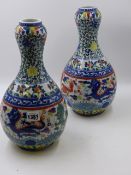 A PAIR OF ORIENTAL BOTTLE FORM VASES WITH DRAGON AND FLORAL DECORATION. H.33cms.