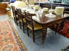 A WM.IV.MAHOGANY EXTENDING DINING TABLE ON TURNED CARVED LEGS WITH LARGE BRASS CASTERS COMPLETE WITH