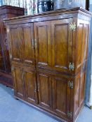 AN ANTIQUE SOLID YEW WOOD PANELLED TWO DOOR CUPBOARD WITH MOULDED CORNICE AND BUN FEET. 176 x