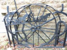 AN IMPRESSIVE PAIR OF LARGE GARDEN GATES CONSTRUCTED FROM VINTAGE FARM MACHINERY.