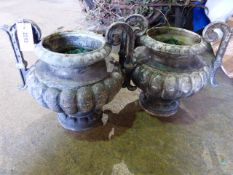A PAIR OF FRENCH IRON TWIN HANDLE GARDEN URNS OF RIBBED FORM. H.35cms.