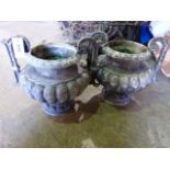 A PAIR OF FRENCH IRON TWIN HANDLE GARDEN URNS OF RIBBED FORM. H.35cms.