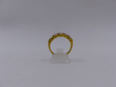 AN 18ct YELLOW GOLD "S" SET BRILLIANT CUT DIAMOND HALF ETERNITY RING, APPROXIMATE TOTAL DIAMOND