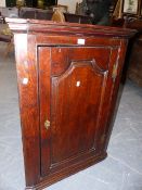 A MID GEORGIAN COUNTRY OAK PANEL DOOR CORNER CABINET. W.70 x H.98cms.