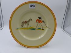 A SUSIE COOPER PLATE DECORATED WITH A COWBOY AND HORSE DESIGN. Dia.25cms.