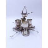 AN ELECTROPLATED FOUR PIECE EGG CUP STAND WITH MATCHING SPOONS WITH A JOCKEY THEME.