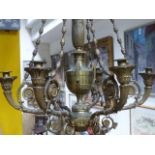 AN ANTIQUE BRASS NEO CLASSICAL STYLE SIX LIGHT CHANDELIER. URN FORM SHAFT WITH SCROLLING BRANCHES.