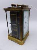 A VICTORIAN BRASS CASED CARRIAGE CLOCK WITH WHITE ENAMEL DIAL COMPLETE WITH LEATHER BOUND CARRY