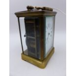 A VICTORIAN BRASS CASED CARRIAGE CLOCK WITH WHITE ENAMEL DIAL COMPLETE WITH LEATHER BOUND CARRY