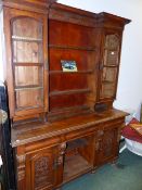 A LATE VICTORIAN OAK DRESSER CABINET WITH GLAZED PANEL PLATE RACK OVER THREE FIREZE DRAWERS AND