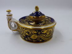 A DERBY PORCELAIN INKWELL WITH GILDED DECORATION ON A DARK BLUE FIELD.