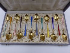 A CASED SET OF TWELVE NORWEGIAN GILDED AND ENAMELLED TEA SPOONS, STAMPED 925 S, THE CASE IS SIGNED