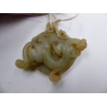 AN ANTIQUE CARVED JADE BI DISC WITH WRITHING DRAGON AMIDST CLOUDS.