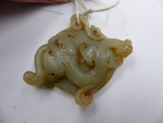 AN ANTIQUE CARVED JADE BI DISC WITH WRITHING DRAGON AMIDST CLOUDS.