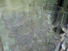 A SET OF SIX EARLY GLASS RUMMERS AND A SET OF SIX EARLY GLASS APERITIFS.